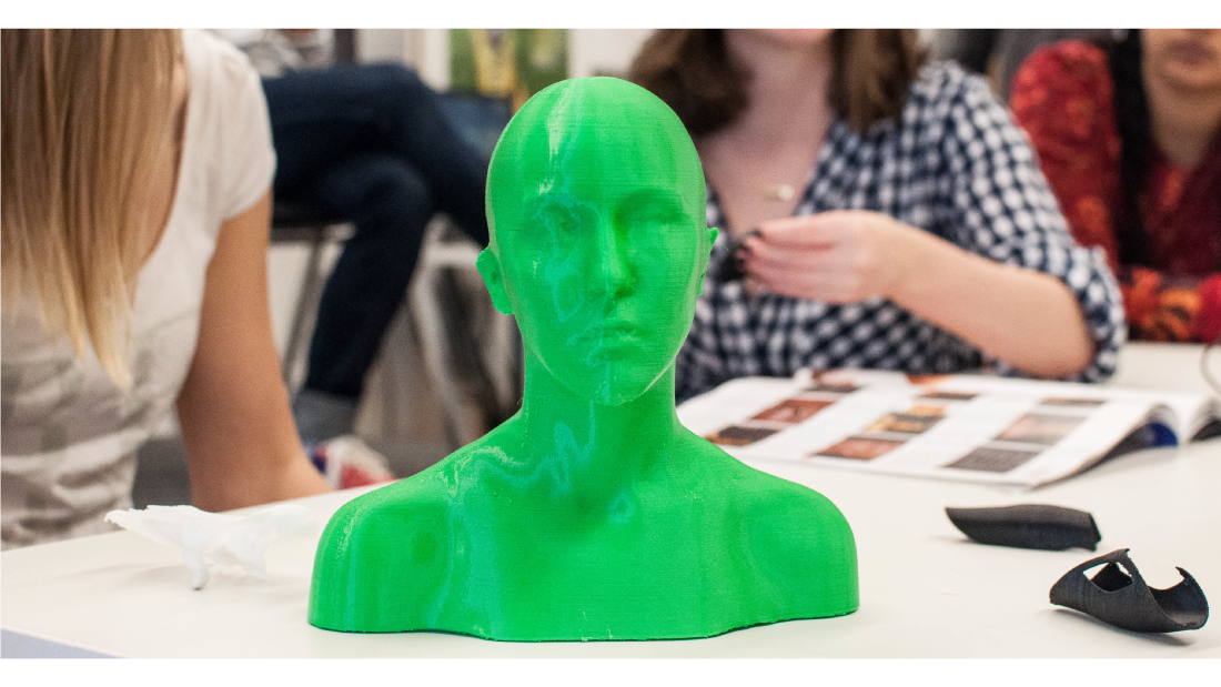 A green, 3D-printed bust of a body scanned student.