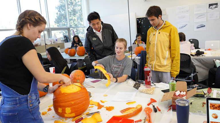 Georgia Tech industrial design students examine pumpkins as a design material for their lesson in Bauhaus designers.