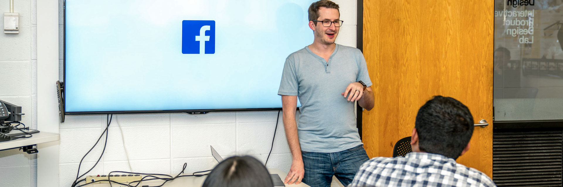 A speaker from Facebook makes a presentation to students.