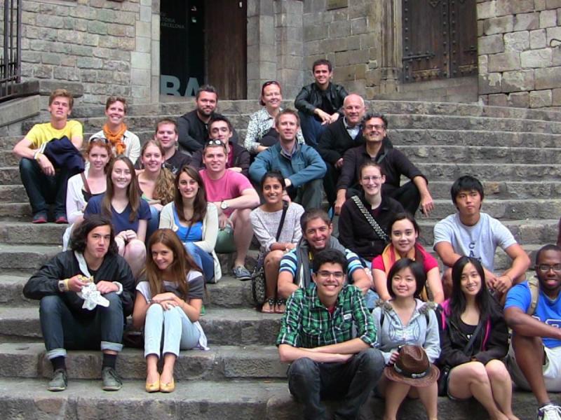 Students studying abroad sit on stone stairway in Barcelona, Spain.