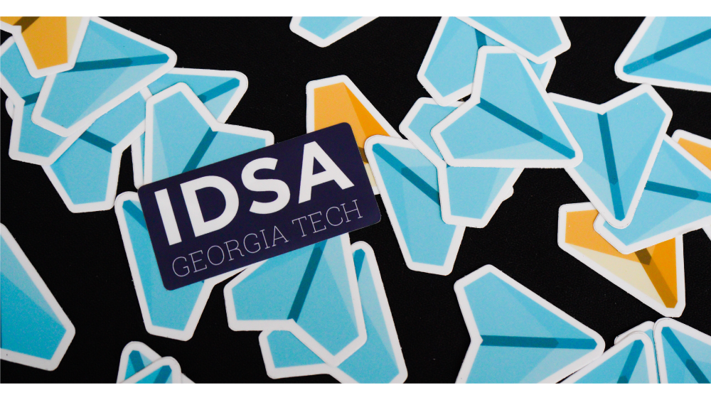 The IDSA logo on top of a colorful pattern of paper airplane designs.